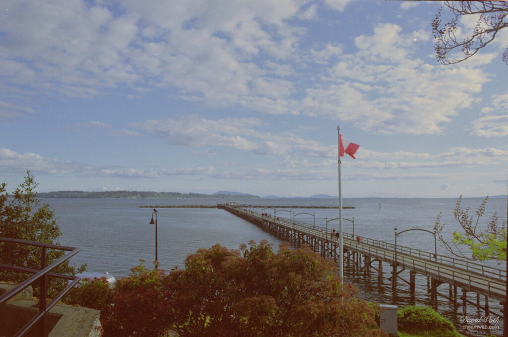 Photo of the the White Rock Pier with a Canadian Flag