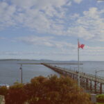Photo of the the White Rock Pier with a Canadian Flag